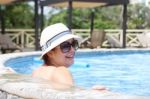 Beautiful Woman Smiling In The Pool Stock Photo