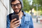 Modern Young Man With Mobile Phone In The Street Stock Photo