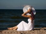 Young Beautiful Woman In A White Dress On The Beach Stock Photo