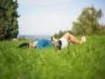 Young Woman Using Mobile Phone In Park Stock Photo