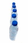 Row Of Plastic Water Bottles Isolated On A White Background Stock Photo