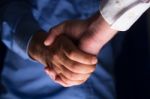 Handshake Handshaking In Dark With Low Light Stock Photo