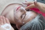 Woman Having Facial Mask At Beauty Salon Stock Photo