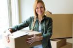 Young Beautiful Woman Moving In A New Home Stock Photo