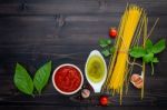 The Thin Spaghetti On Black Wooden Background. Yellow Italian Pa Stock Photo