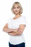 Confident Woman In Trendy Wear With Arms Folded Stock Photo