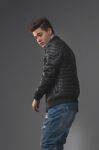 Casual Young Man In Black Leather Jacket And Denim Jeans Stock Photo