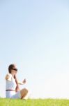 Young Women Sitting And Doing Meditating Stock Photo