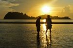 Girls And Boy On The Hat Sai Ri Beach During Sunrise Stock Photo