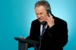 Irritated Businessman Communicating On Phone Stock Photo