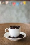 Coffee Cup Or Coffee Beans On Wooden Table In The Coffee Shop Stock Photo