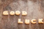 Good Luck Alphabet Biscuit On Wooden Table Stock Photo