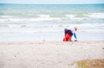 Man Cleaning Rubbish At Beach Stock Photo