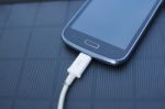 Mobile Phone Charging With Solar Energy - Charger Stock Photo