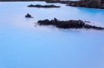 Milky White And Blue Water Between The Lava Stones Covered With Moss Stock Photo