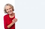 Aged Woman Holding Blank Ad Board Stock Photo