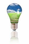 Light Bulb With Blue Sky And Grass Stock Photo