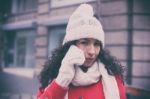 Girl In Red Coat And Wool Cap And Gloves With Smartphone In Hand Stock Photo