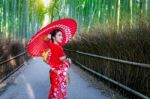 Bamboo Forest. Asian Woman Wearing Japanese Traditional Kimono At Bamboo Forest In Kyoto, Japan Stock Photo