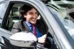 Handsome Businessman Driving A Luxurious Car Stock Photo