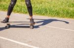 Young Woman Skateboarding In The Park Stock Photo