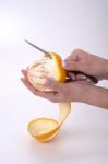 Woman Hands Peeling An Orange With A Knife Stock Photo