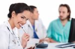 Young Doctor Smiling With Pen Stock Photo