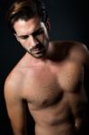 Handsome Muscular Male Model Posing Over Black Background Stock Photo