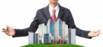 Business Man And Modern Building On Green Grass Field Stock Photo