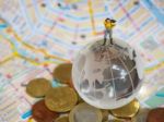 Miniature Traveller Or Backpacker Stand On Globe Of Glass, Euro Stock Photo