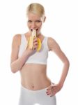 Starving Woman Eating Banana Stock Photo