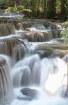 The Water Flowing Over Rocks And Trees Down A Waterfall At Huay Mae Khamin Waterfall National Park ,kanchana Buri In Thailand Stock Photo