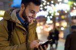 Portrait Of Young Man Using His Mobile Phone On The Street At Ni Stock Photo