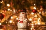 Festive Snowman With Christmas Light Background Stock Photo