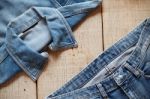 Old Jeans On Wooden Stock Photo