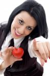 Female Holding A Red Heart Pointing At Camera Stock Photo