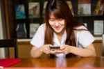 Portrait Of Thai Adult Student University Uniform Beautiful Girl Using Her Smart Phone Stock Photo