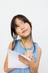 Portrait Of A Cute Little Asian Girl Thinking Stock Photo