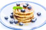 Pile Of Pancakes With Blueberries Sprinkled With Icing Sugar And Stock Photo