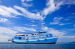 Passenger Wooden Boat Floating On Blue Sea Water With Beautiful Stock Photo