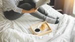 Woman Reading Book Or Newspaper And Drinking Coffee Breakfast On Stock Photo