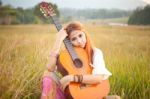 Hippie Girl Playing Guitar On Grass Stock Photo