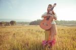 Hippie Woman Walking In Golden Field Stock Photo