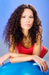 Pretty Curls Hair Women On Blue Pilates Ball Stock Photo