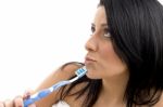 Portrait Of Female Looking Upward With Toothbrush Stock Photo