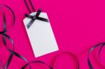 Tag With Ribbon On Pink Stock Photo