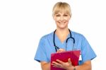 Shot Of A Cheerful Doctor Doing Her Rounds Stock Photo