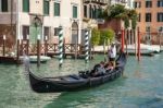 Gondolier Ferrying People In Venice Stock Photo