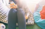 Woman Typing Text Message On Smart Phone In A Cafe Stock Photo