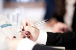 Woman Cross-checking Business Reports Stock Photo